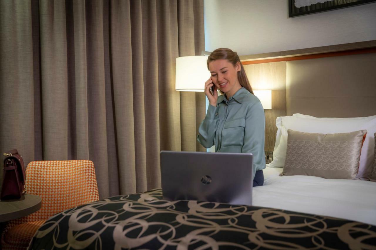 Clayton Hotel Dublin Airport Coolock Dış mekan fotoğraf A woman working from home.